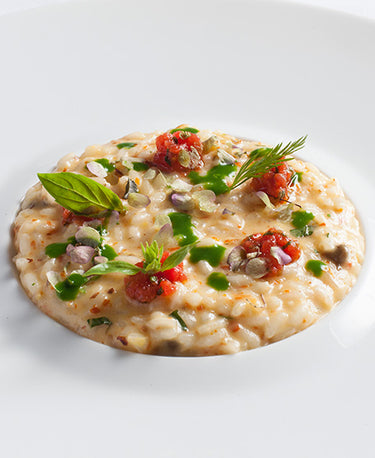 foto ricetta RISOTTO CON CAPPERI DI PANTELLERIA, LIMONI DELLA COSTIERA, ACCIUGHE DI MONTEROSSO, MANDORLE DI TORITTO E SUCCO DI CRESCIONE 